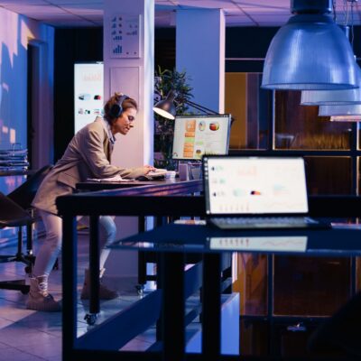 Young employee using AI for analysis in futuristic office